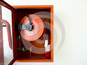 Fire extinguisher with various types of fire extinguishers Located In the white wall. copy space for text and content