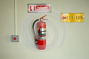 Fire extinguisher on the white wall.