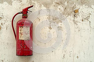 fire extinguisher on white wall, close up
