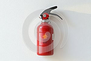 fire extinguisher on white wall, close up
