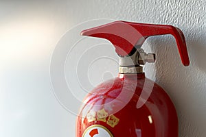 fire extinguisher on white wall, close up