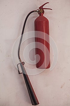 Fire extinguisher on a white wall industrial