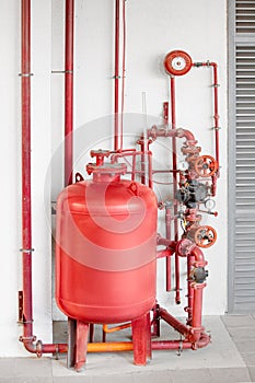 Fire extinguishing and fire alarm system with complex and intricate scheme of pipes, assemblies and a large foam tank photo