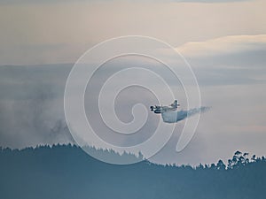 Fire extinguishing plane water bomber dumping its load, Spain