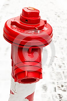 Fire extinguishing system hydrant metallic red close-up adapter for hose against a background of snowy area