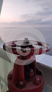 Fire faucet on the ship's rail on a sunny day