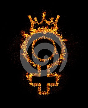 Fire female gender sign with queen crown burning in flames, isolated on black background with bright sparkles. Sex rights, girl