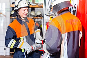 Fire fighter checking hydraulic cutter at fire engine