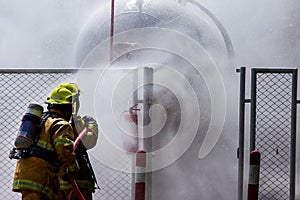 A fire fighter is controlling a fire