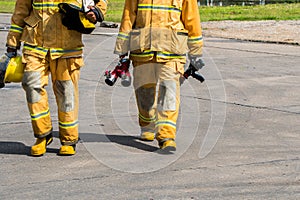 Fire fighter in full gear standing outside a steel building ready to go in