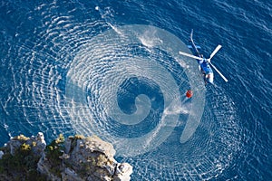 Fire fighter helicopter collect water over the sea