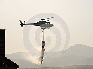 Fire fighter helicopter dropping water in Colmenar Viejo Spain