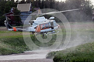 Fire fighter helicopter hovering over a small river