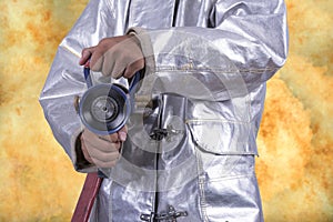 Fire fighter hold fire hose on fire background