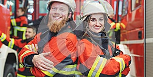 Fire fighter man and woman standing shoulder to shoulder photo