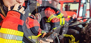 Fire fighter woman on duty using the radio