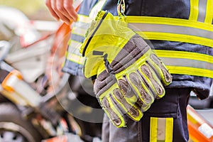 Fire fighter works with professional tools on a crashed car