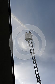 Fire fighters on a fire ladder