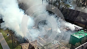 Fire fighters have their work cut out for them as they try to contain huge fire during high winds causing black smoke. footage