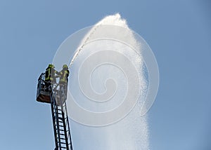 Fire fighters spraying water
