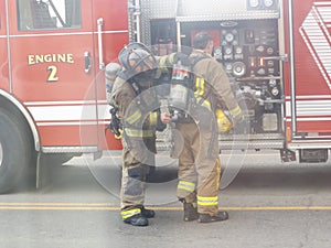 Fire fighters suiting up to fight fires