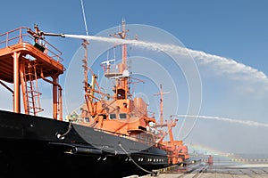 Fire fighting boat sprays water in port.The fire ship is testing the fire fighting equipment in the port