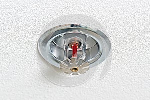 Fire fighting equipment, sprinkler on white ceiling