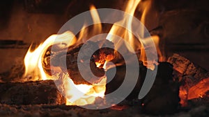 Fire in the fireplace. Firewood, coal, flame. Burning Fireplace - a luminous fire in a stone fireplace to keep warm at