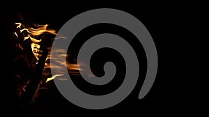 Fire flame isolated black isolated background Beautiful orange. Flame border . Sparks from campfire