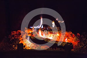 Fire flames with ash in fireplace