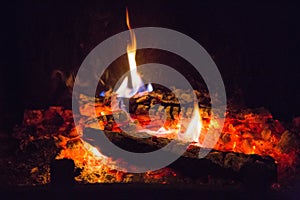 Fire flames with ash in fireplace
