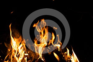 Fire flames on a black background. Abstract fiery texture. Realistic fire flames burn movement frame. Texture for Design. The