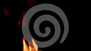 Fire flames on a black background. Abstract fiery texture. Realistic fire flames burn movement frame. Texture of fire for Design.