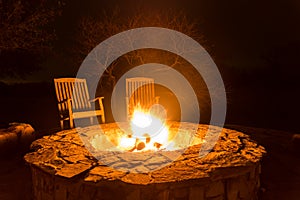 Fire flames in a fire pit at night photo