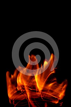 Fire flames isolated on a black backdrop. Abstract fire background