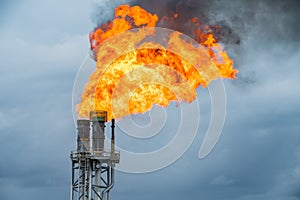 Fire on flare stack at oil and gas central processing platform while burning toxic and release over pressure from process photo