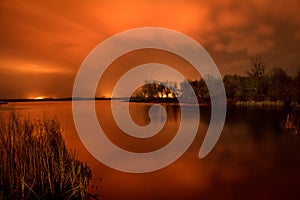 Fire in the floodlands on the river. Night photo. Dnieper River Delta.