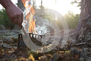 Fire in forest camp. Special small splinter tourist campfire.