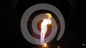 Fire from gas jet burner in hot air balloon during aerostat festival at night