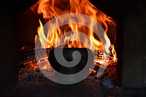 Fire hearth of russian oven and old cast-iron pot