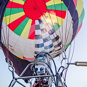 Fire heats the air inside a hot ai r balloon at balloon festival