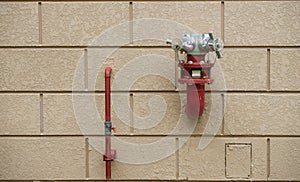 Fire hydrant on brick wall for ceasing fire outdoors building