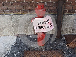 fire hydrant with fuori servizio (out of order) sign