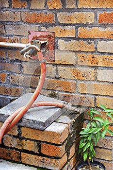 Fire hydrant hose installed at brick wall