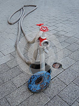 Fire hydrant in street with hose