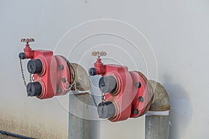 fire hydrants on a white house wall 1