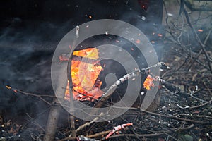 Fire inside a metal drum incinerator