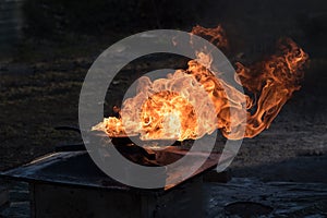 Fire on an iron pan, extinguishing demonstration during a fire d