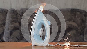 The fire of the ironing iron in the apartment, sparks faulty wiring, short circuit. Concept: the cause of the fire in the house, l