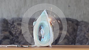 The fire of the ironing iron in the apartment, sparks faulty wiring, short circuit. Concept: the cause of the fire in the house, l